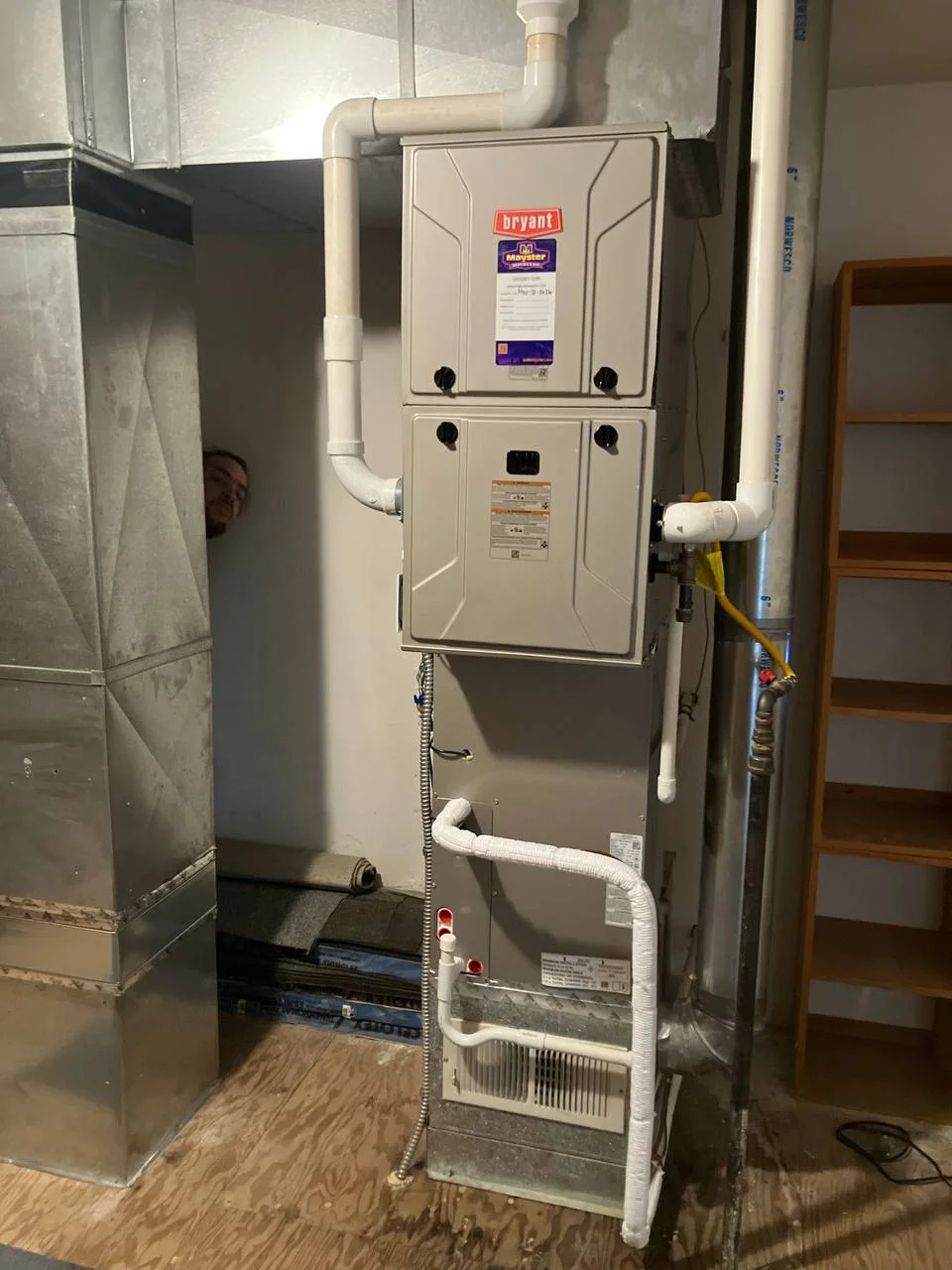 Modern Bryant heating unit installed in a utility room with PVC piping, relying on Furnace Services Greater Puget Sound.