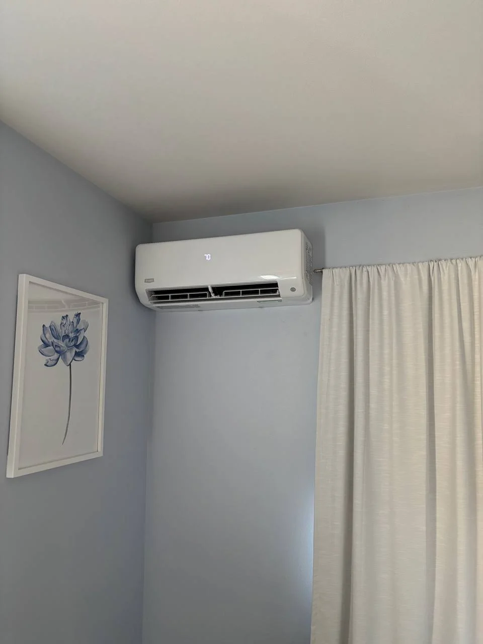 Modern wall-mounted air conditioner indoor unit with digital display providing Mini Split Services Greater Puget Sound.