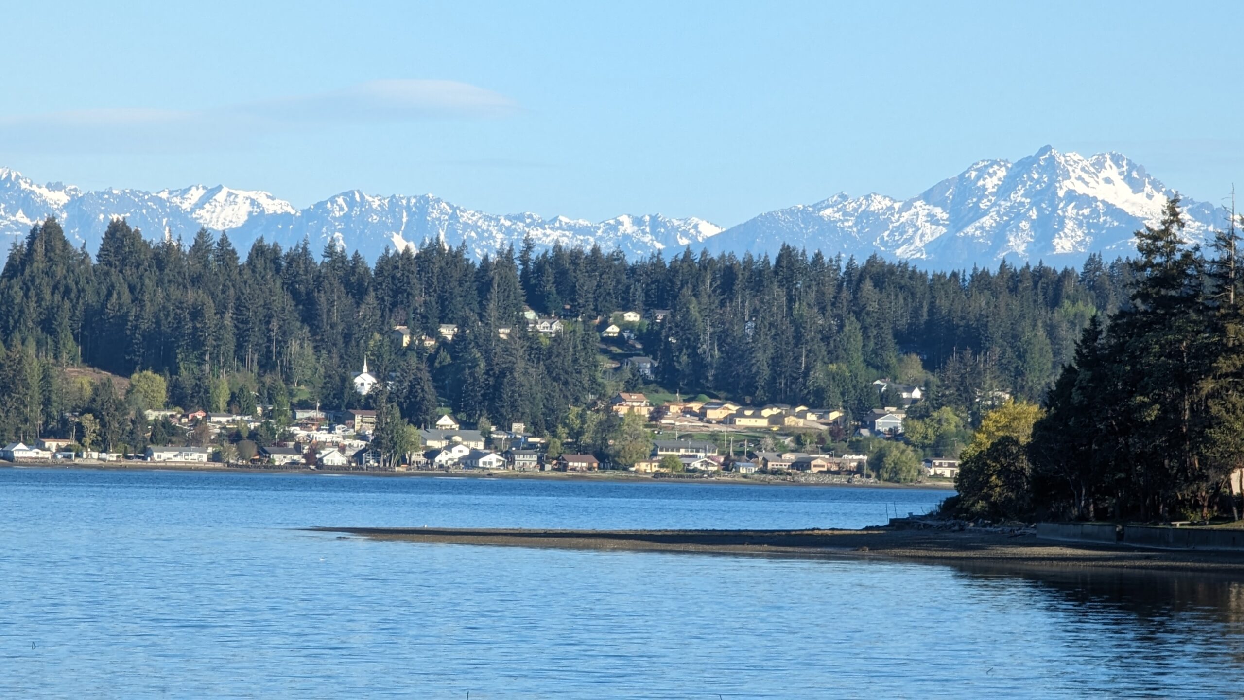 Snow-capped Olympic Mountains above the Allyn waterfront, where Mayster delivers HVAC services in Allyn WA to nearby families