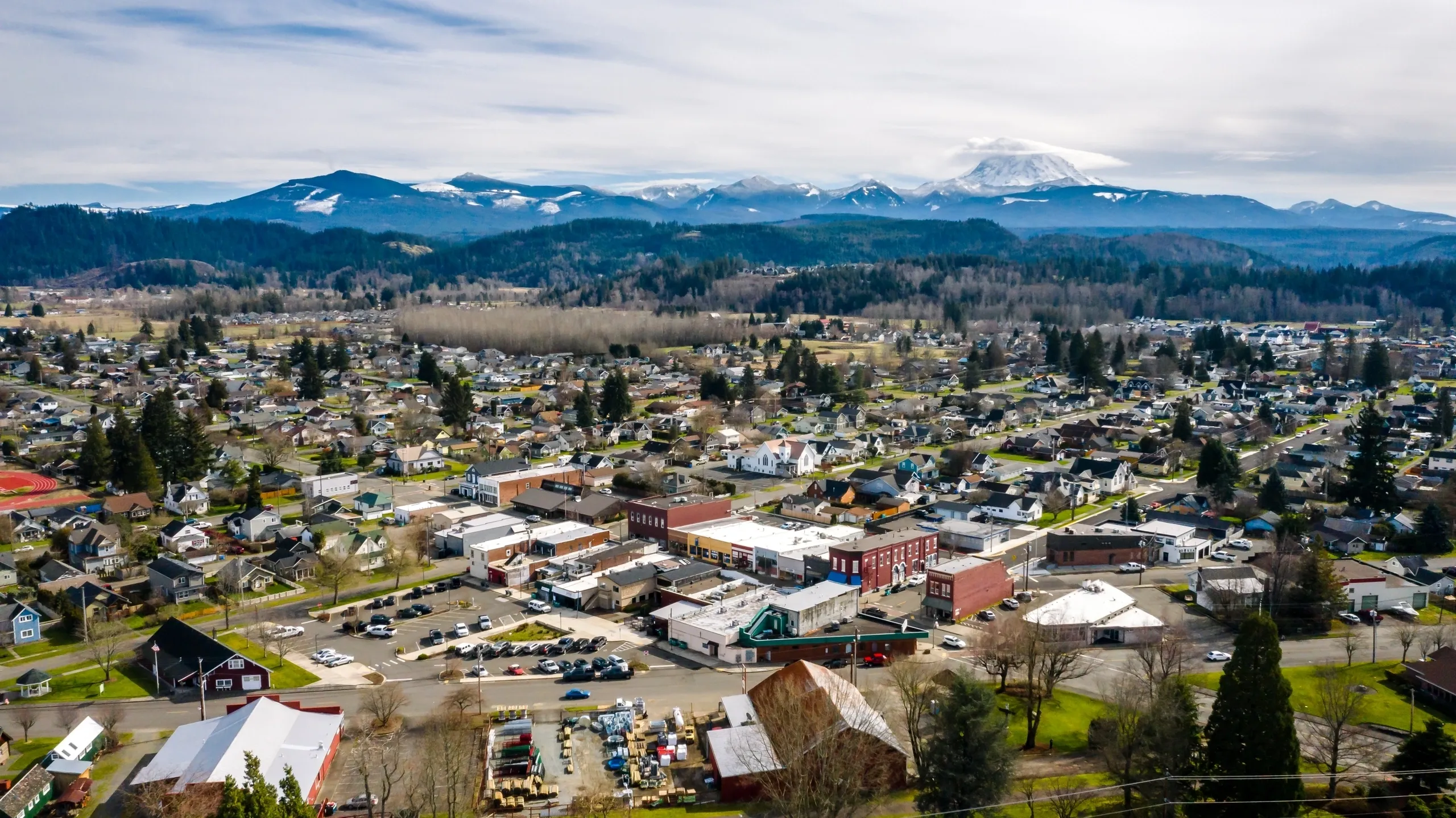 Aerial view of Buckley homes with snowy mountains on the horizon, where Mayster delivers HVAC services in Buckley WA to nearby families