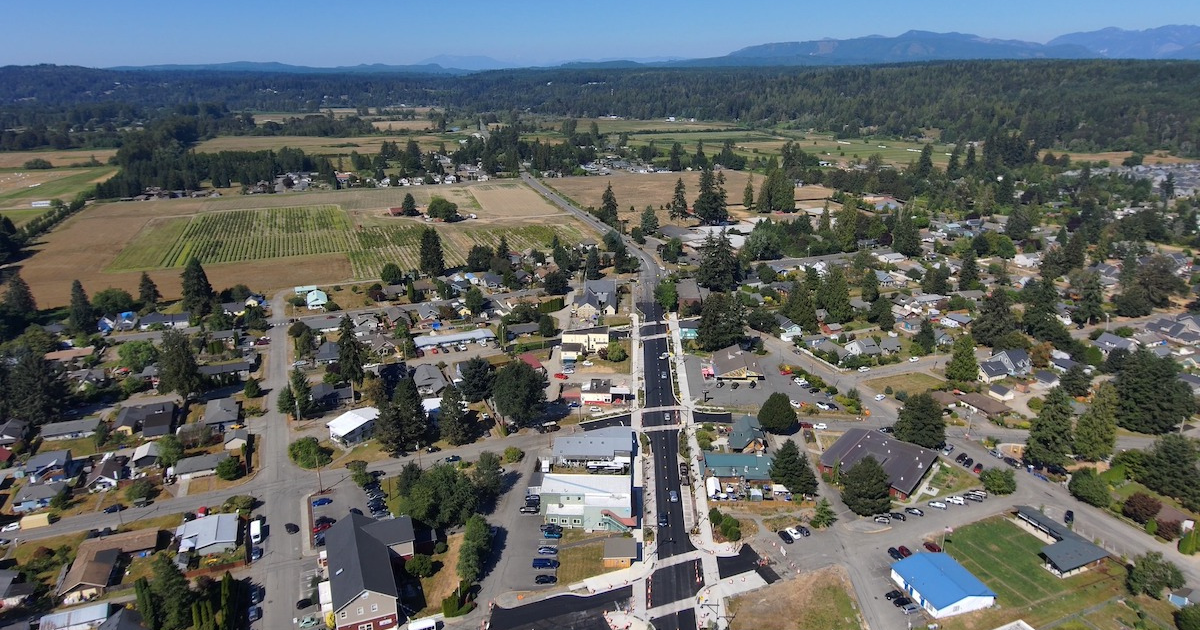 Aerial view of the town of Carnation surrounded by farmland and hills, a community where Mayster offers HVAC services in Carnation WA to homeowners