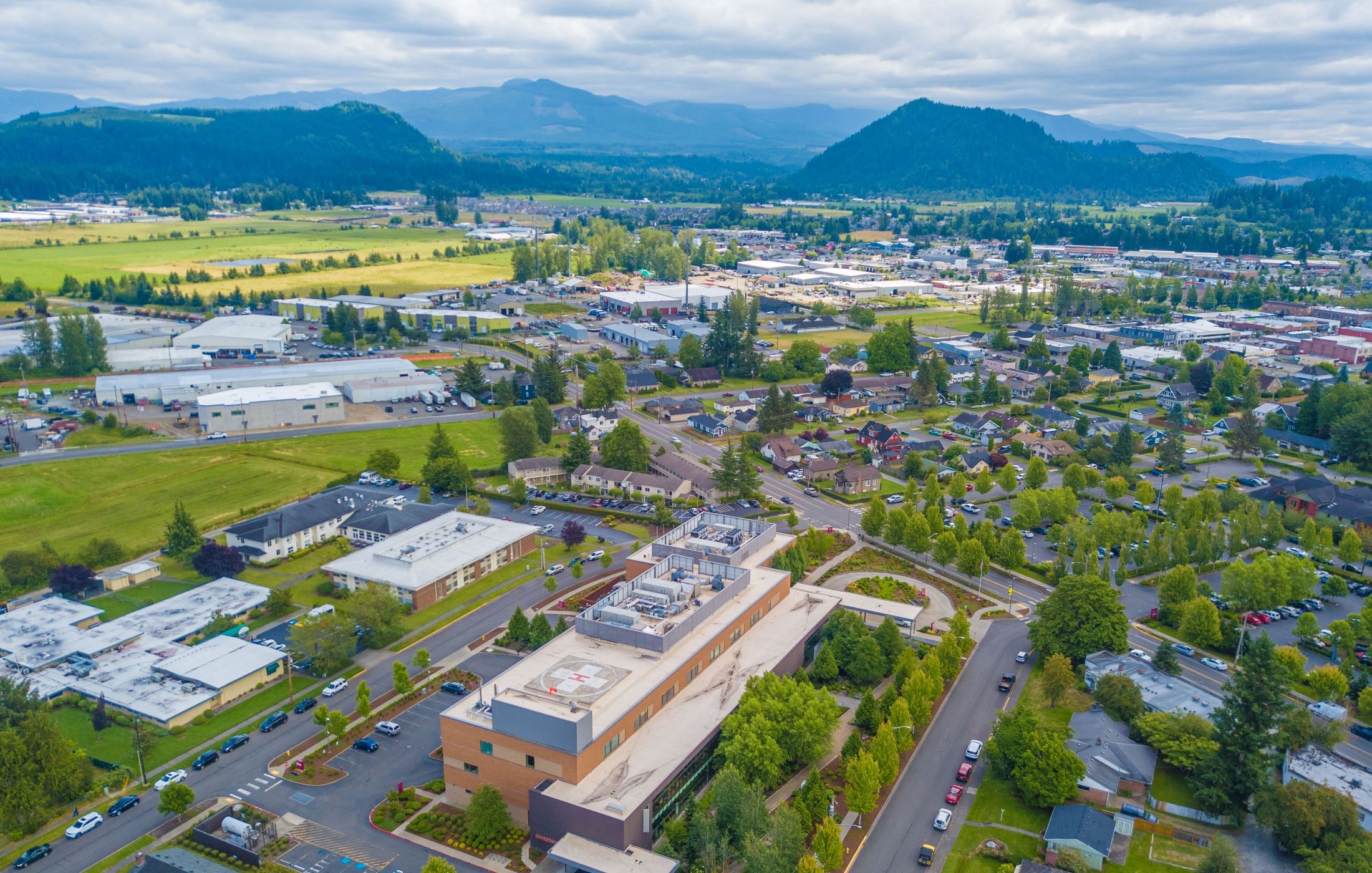 Aerial view of Enumclaw streets and buildings with forested hills behind, a community where Mayster offers HVAC services in Enumclaw WA to homeowners