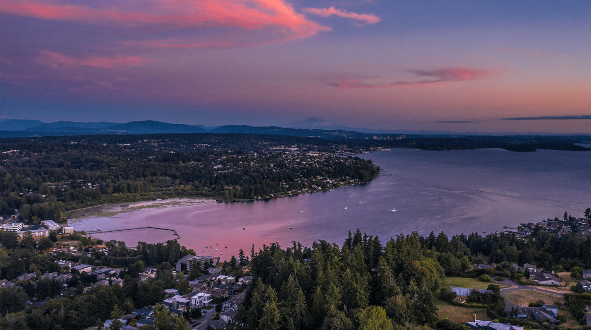 Pink sunset over the Kirkland shoreline and Lake Washington, a lakeside city where Mayster delivers HVAC services in Kirkland WA to homeowners