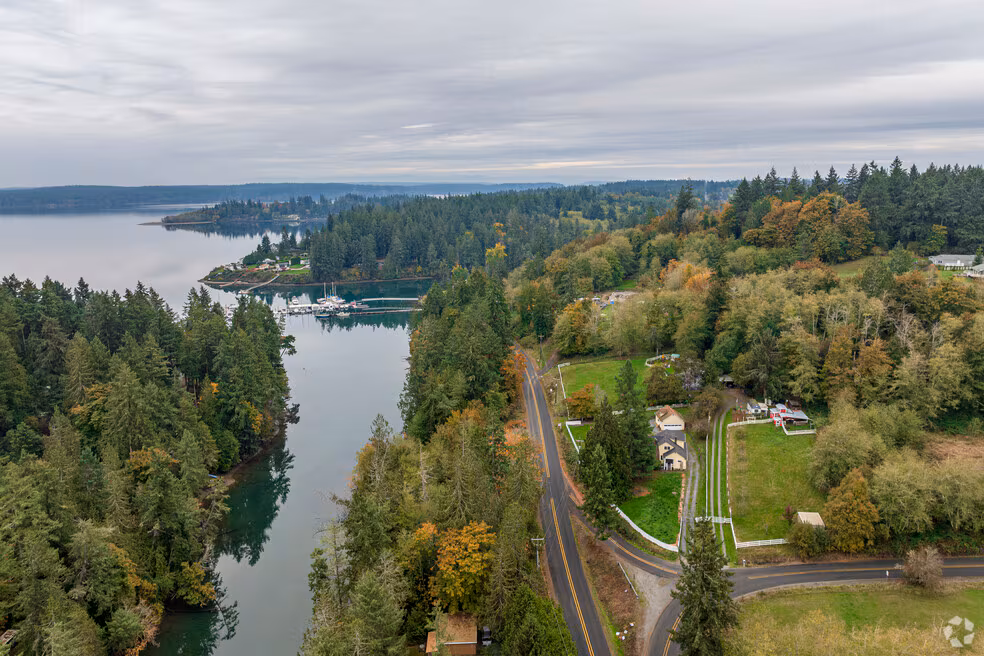 Aerial view of a Longbranch inlet bordered by forest and fields, a community where Mayster offers HVAC services in Longbranch WA to homeowners