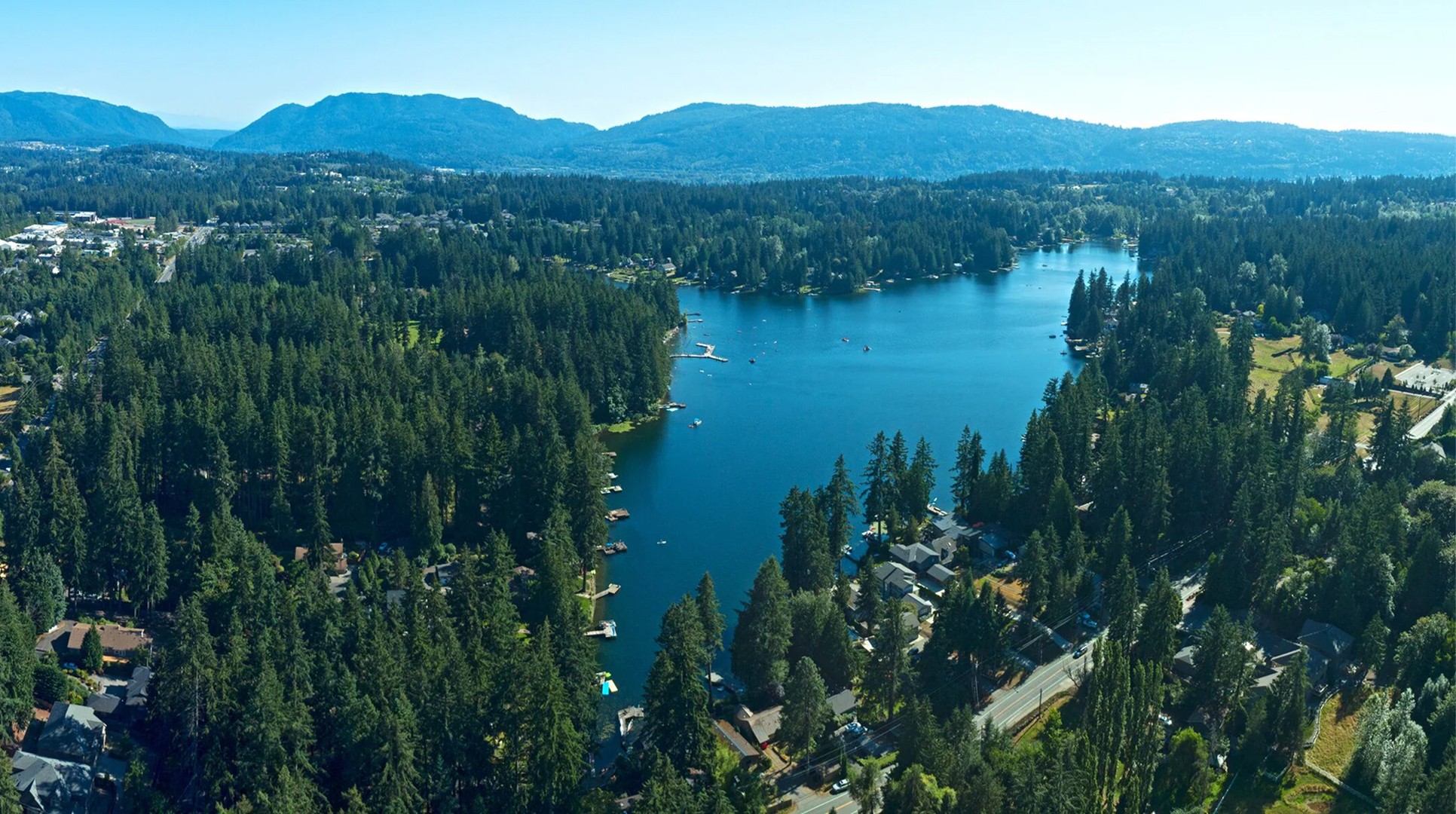 Aerial view of a forest-lined lake on the Sammamish plateau, where Mayster provides HVAC services in Sammamish WA for families across the area
