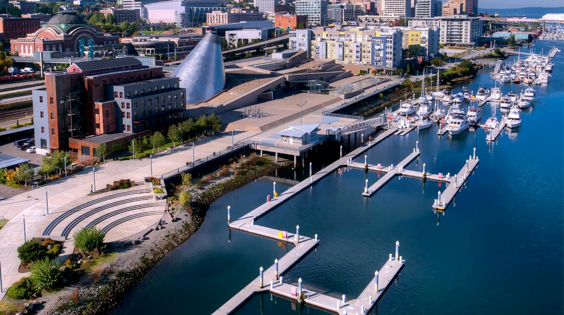 Aerial view of the Tacoma waterfront marina with boats near downtown buildings, where Mayster offers HVAC services in Tacoma WA to local homes