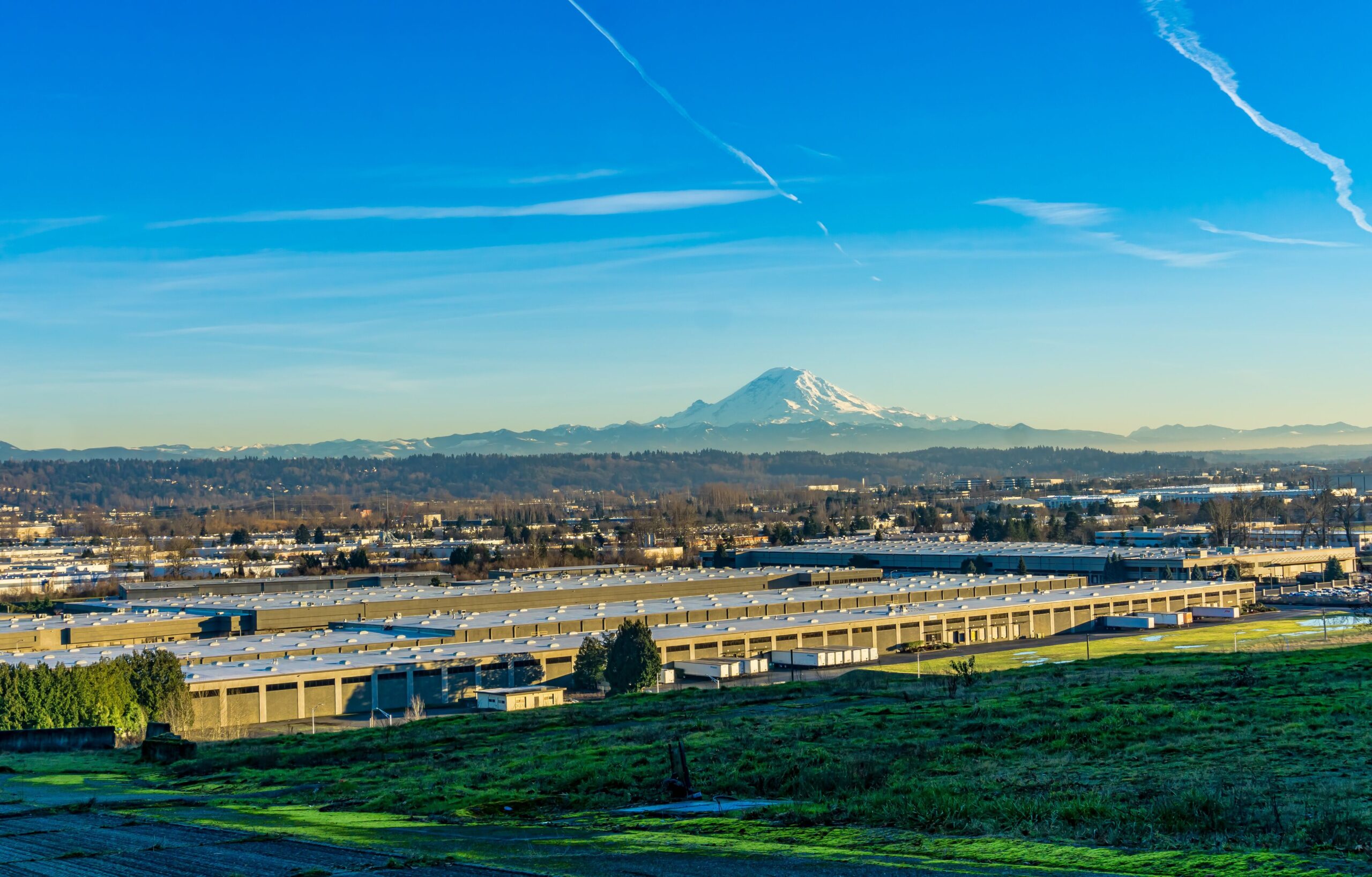 Aerial view of Tukwila with Mount Rainier rising in the distance, where Mayster delivers HVAC services in Tukwila WA to nearby families