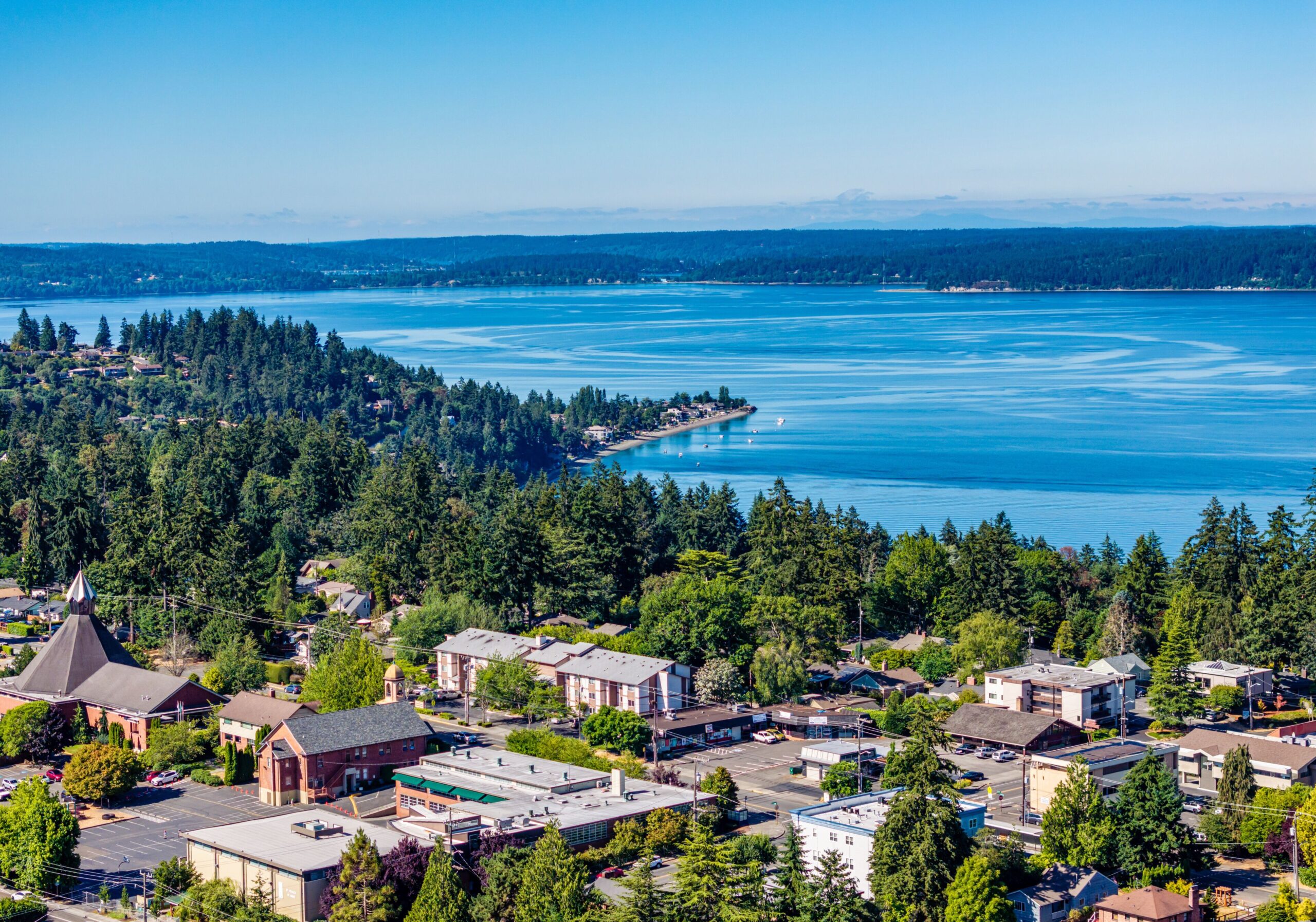 Aerial view of Burien homes and trees along the Puget Sound shoreline, where Mayster provides HVAC services in Burien WA for local homes
