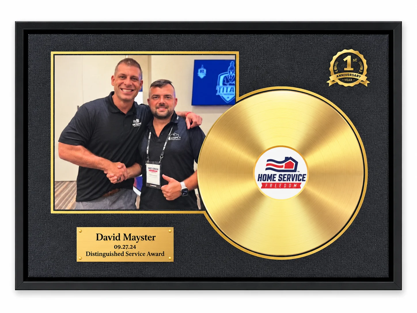 A framed award featuring a picture of David Mayster with a colleague, a gold record, and a 1st anniversary seal.