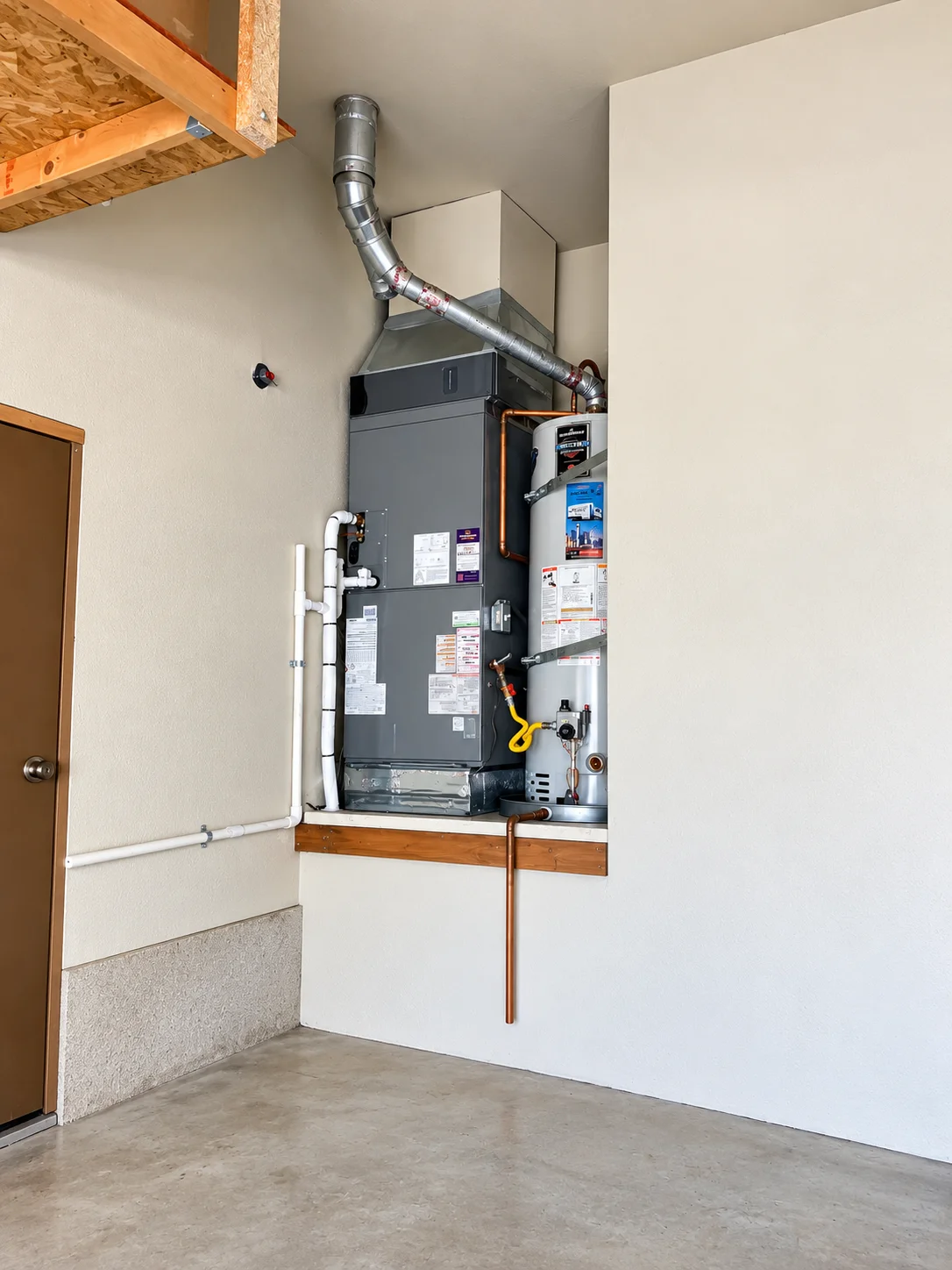 Modern HVAC unit and water heater installed in garage utility space during air handler installation Greater Puget Sound.
