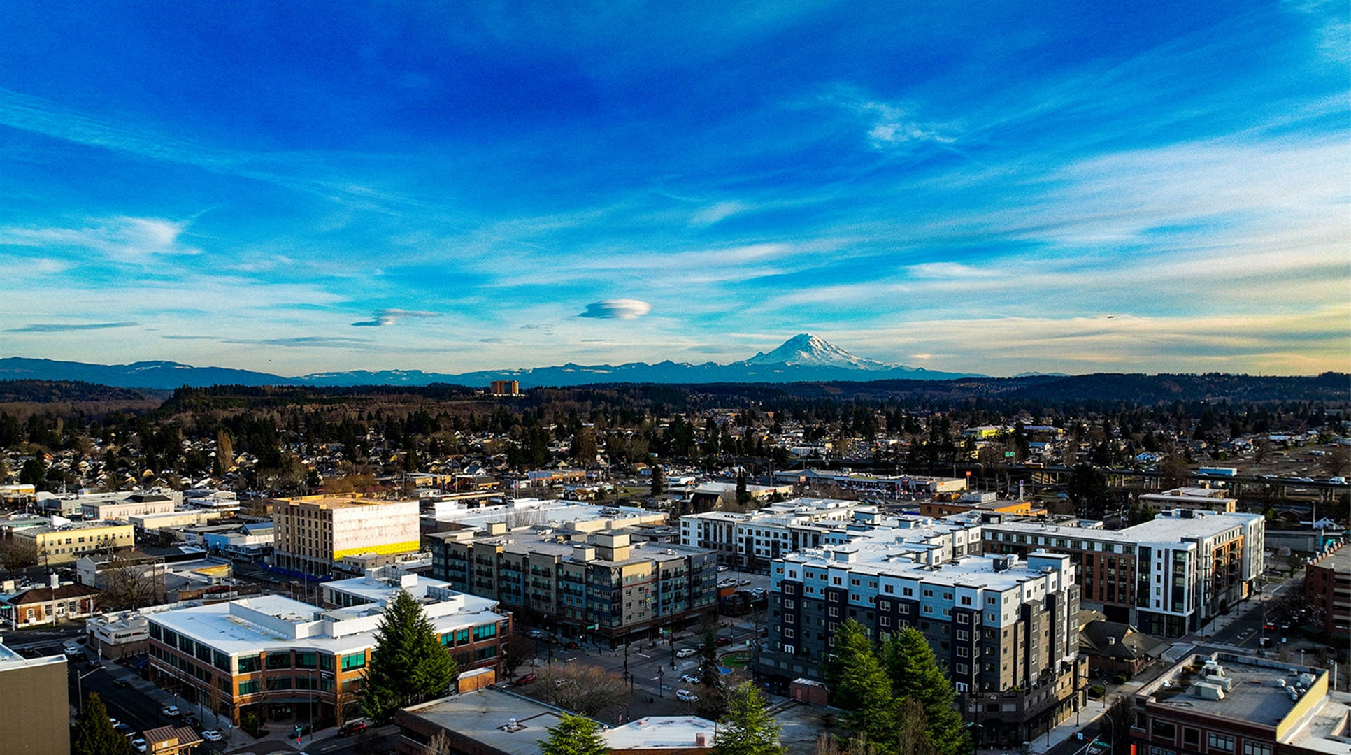 Aerial view of downtown Auburn buildings with Mount Rainier on the horizon, where Mayster delivers HVAC services in Auburn WA to nearby homeowners