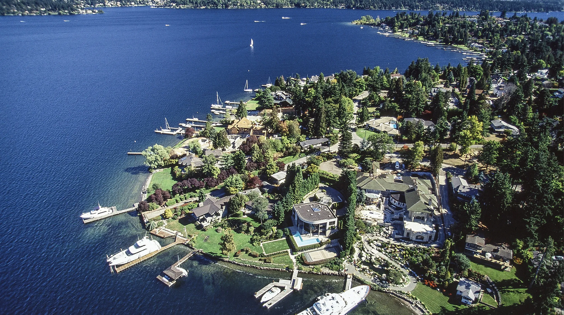Aerial view of the Mercer Island shoreline with private docks and boats on Lake Washington, where Mayster provides HVAC services in Mercer Island WA for local homes