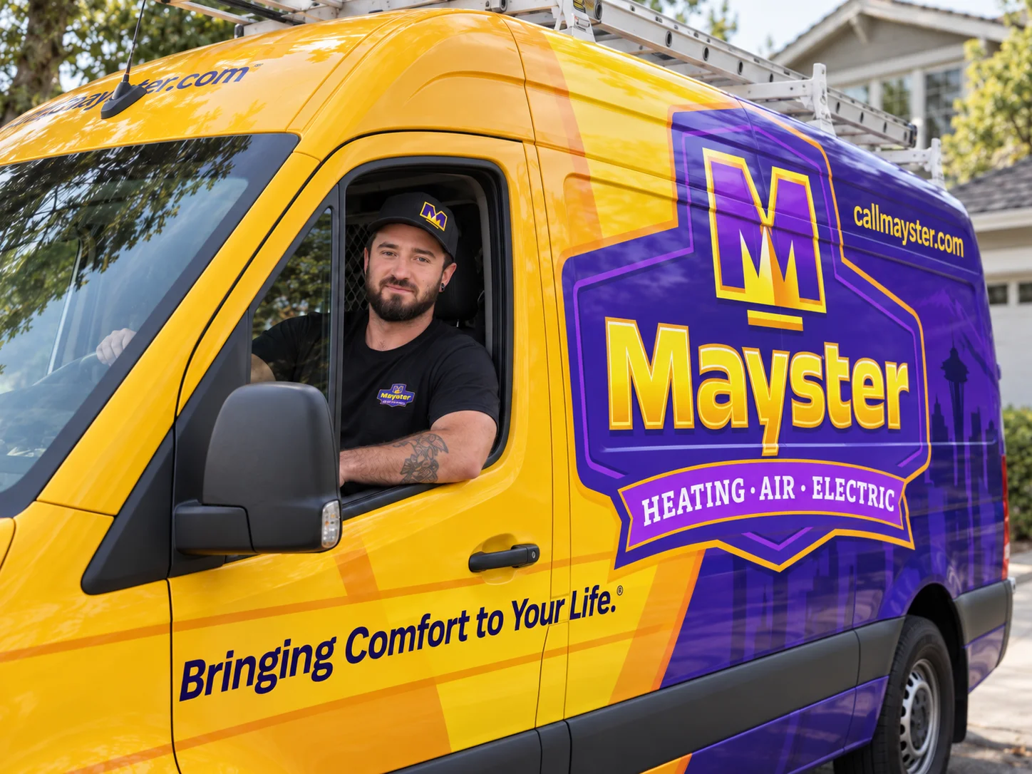 Friendly technician smiling from a branded service van delivering HVAC services Puget Sound