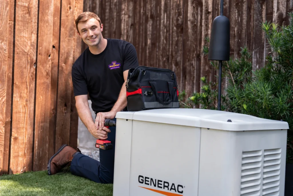 Technician with drill servicing a standby system for expert Whole-House Generator Services Greater Puget Sound.